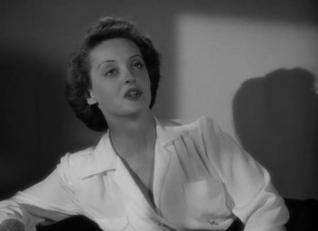 Movie still from “The Letter” (1940), directed by William Wyler – An old photo of a woman sitting in a chair; Close Up shot, Low angle