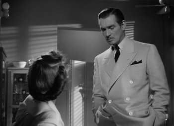 Movie still from “The Letter” (1940), directed by William Wyler – A man and a woman are standing in front of a window; Medium shot, Low angle