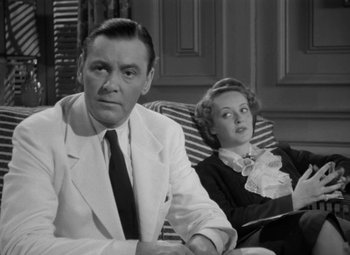 Movie still from “The Letter” (1940), directed by William Wyler – A man and a woman sitting on a couch; Medium shot, Low angle