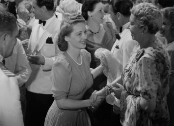 Movie still from “The Letter” (1940), directed by William Wyler – An old black and white photo of a group of people; Medium shot, High angle