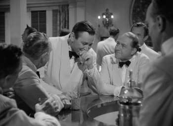 Movie still from “The Letter” (1940), directed by William Wyler – A group of men sitting around a table; Medium shot, Over the shoulder angle