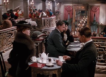 Movie still from “The Life and Death of Colonel Blimp” (1943), directed by Emeric Pressburger – A group of people sitting at a table in a restaurant; Wide shot, High angle