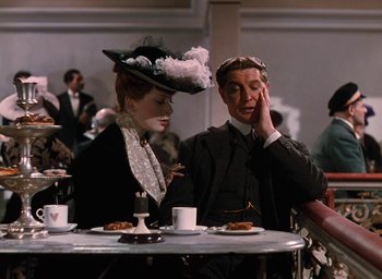 Movie still from “The Life and Death of Colonel Blimp” (1943), directed by Emeric Pressburger – A man and a woman sitting at a table in front of each other; Medium shot, Over the shoulder angle
