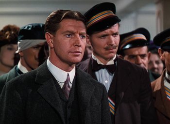 Movie still from “The Life and Death of Colonel Blimp” (1943), directed by Emeric Pressburger – A group of men standing next to each other in suits; Medium shot, Low angle