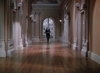 Movie still from “The Life and Death of Colonel Blimp” (1943), directed by Emeric Pressburger – A man walking down a hallway in a building; Extreme Wide shot, High angle