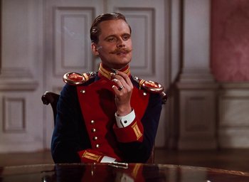 Movie still from “The Life and Death of Colonel Blimp” (1943), directed by Emeric Pressburger – A man sitting at a table wearing a military uniform; Close Up shot, Low angle