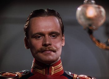 Movie still from “The Life and Death of Colonel Blimp” (1943), directed by Emeric Pressburger – A person wearing a uniform with a mustache; Close Up shot, Low angle