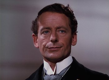 Movie still from “The Life and Death of Colonel Blimp” (1943), directed by Emeric Pressburger – A person wearing a suit and tie; Close Up shot, Low angle