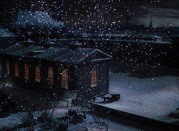 Movie still from “The Life and Death of Colonel Blimp” (1943), directed by Emeric Pressburger – A snowy night scene with a building in the background; Extreme Wide shot, High angle