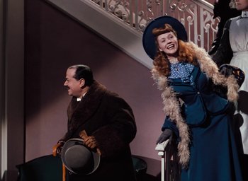 Movie still from “The Life and Death of Colonel Blimp” (1943), directed by Emeric Pressburger – A man and a woman standing next to each other on stairs; Medium shot, Low angle