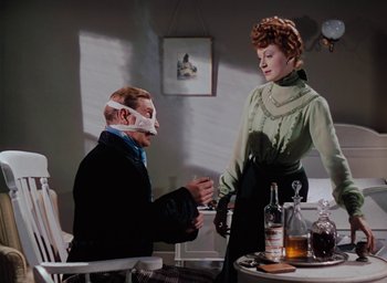 Movie still from “The Life and Death of Colonel Blimp” (1943), directed by Emeric Pressburger – A man and a woman sitting at a dinner table; Medium shot, High angle