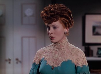 Movie still from “The Life and Death of Colonel Blimp” (1943), directed by Emeric Pressburger – A woman in a blue and white dress with red hair; Close Up shot, Over the shoulder angle