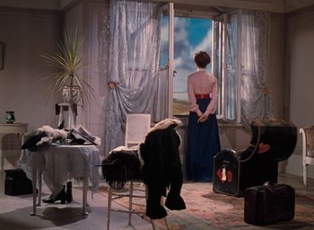 Movie still from “The Life and Death of Colonel Blimp” (1943), directed by Emeric Pressburger – A woman in a blue dress looking out of a window; Wide shot, Low angle