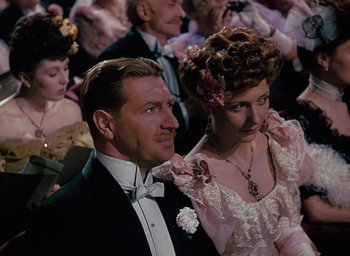 Movie still from “The Life and Death of Colonel Blimp” (1943), directed by Emeric Pressburger – A man and a woman dressed in formal wear; Medium shot, Low angle