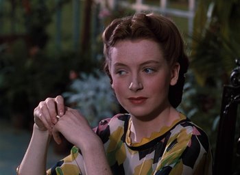 Movie still from “The Life and Death of Colonel Blimp” (1943), directed by Emeric Pressburger – A woman in a yellow and black floral print dress; Close Up shot, Over the shoulder angle