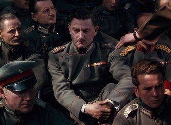 Movie still from “The Life and Death of Colonel Blimp” (1943), directed by Emeric Pressburger – A group of men in uniform are gathered together; Medium shot, High angle