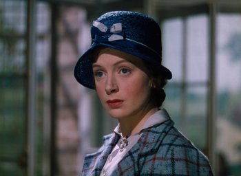 Movie still from “The Life and Death of Colonel Blimp” (1943), directed by Emeric Pressburger – A woman wearing a blue hat and a plaid jacket; Close Up shot, High angle