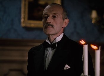Movie still from “The Life and Death of Colonel Blimp” (1943), directed by Emeric Pressburger – A man in a tuxedo standing in front of a lit candle; Close Up shot, Low angle