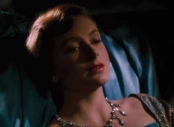 Movie still from “The Life and Death of Colonel Blimp” (1943), directed by Emeric Pressburger – A woman wearing a diamond necklace and earrings; Close Up shot, High angle