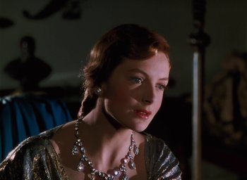 Movie still from “The Life and Death of Colonel Blimp” (1943), directed by Emeric Pressburger – A woman wearing a silver dress and a necklace; Close Up shot, Over the shoulder angle
