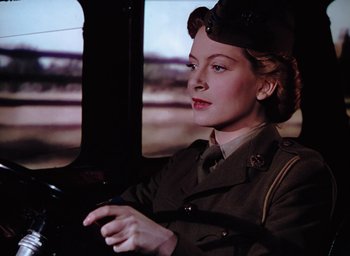 Movie still from “The Life and Death of Colonel Blimp” (1943), directed by Emeric Pressburger – A woman in a military uniform driving a car; Close Up shot, Low angle