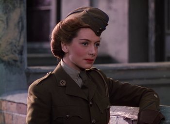 Movie still from “The Life and Death of Colonel Blimp” (1943), directed by Emeric Pressburger – A woman in a military uniform with a hat on her head; Close Up shot, Low angle