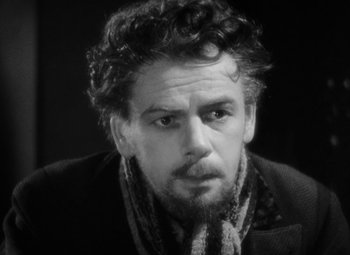 Movie still from “The Life of Emile Zola” (1937), directed by William Dieterle – Black and white photograph of a man with curly hair; Close Up shot, High angle