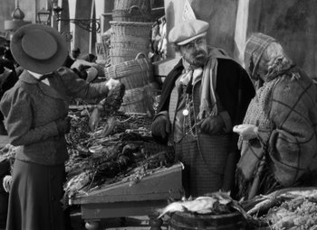 Movie still from “The Life of Emile Zola” (1937), directed by William Dieterle – An old photo of a group of people at an outdoor market; Medium shot, High angle