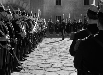 Movie still from “The Life of Emile Zola” (1937), directed by William Dieterle – A black and white photo of a group of men in uniform; Wide shot, High angle