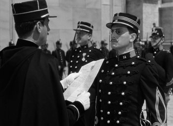 Movie still from “The Life of Emile Zola” (1937), directed by William Dieterle – A group of men in uniform holding papers; Medium shot, Low angle