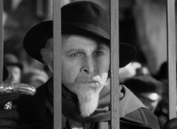Movie still from “The Life of Emile Zola” (1937), directed by William Dieterle – A man with a beard wearing a hat and a scarf; Close Up shot, Low angle