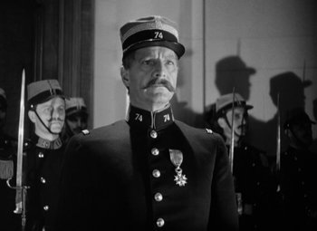 Movie still from “The Life of Emile Zola” (1937), directed by William Dieterle – A black and white photo of a man in a military uniform; Close Up shot, Low angle