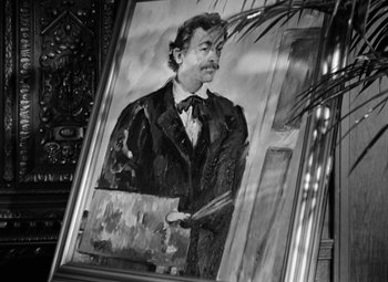 Movie still from “The Life of Emile Zola” (1937), directed by William Dieterle – A black and white picture of a man holding a paintbrush; Close Up shot, Low angle