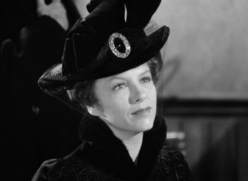 Movie still from “The Life of Emile Zola” (1937), directed by William Dieterle – A black and white photo of a woman wearing a hat; Close Up shot, Low angle
