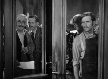 Movie still from “The Life of Emile Zola” (1937), directed by William Dieterle – A black and white photo of a group of men standing next to each other; Medium shot, Over the shoulder angle