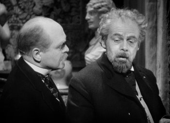 Movie still from “The Life of Emile Zola” (1937), directed by William Dieterle – A man with a beard and mustache and a man with a beard and mustache; Medium shot, Over the shoulder angle