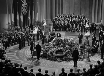 Movie still from “The Life of Emile Zola” (1937), directed by William Dieterle – A crowd of people standing in front of an urn with flowers on it; Extreme Wide shot, High angle