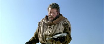 Movie still from “The Lion in Winter” (1968), directed by Anthony Harvey – A bearded man in medieval garb holding a sword; Medium shot, Low angle