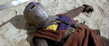 Movie still from “The Lion in Winter” (1968), directed by Anthony Harvey – A knight's helmet and armor on the ground; Medium shot, High angle