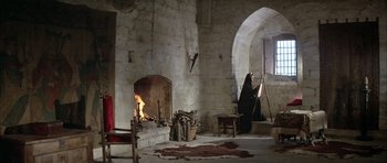 Movie still from “The Lion in Winter” (1968), directed by Anthony Harvey – A room with a fire place and a fireplace in it; Wide shot, High angle