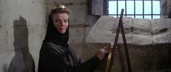 Movie still from “The Lion in Winter” (1968), directed by Anthony Harvey – A woman wearing a crown painting on a canvas; Medium shot, Low angle