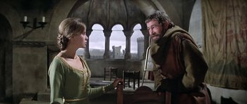 Movie still from “The Lion in Winter” (1968), directed by Anthony Harvey – A man and a woman in medieval garb in a room; Medium shot, Over the shoulder angle
