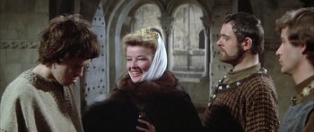 Movie still from “The Lion in Winter” (1968), directed by Anthony Harvey – A woman wearing a crown and a fur coat; Medium shot, Over the shoulder angle