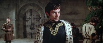 Movie still from “The Lion in Winter” (1968), directed by Anthony Harvey – A man in a black shirt and a fur cape; Medium shot, Low angle