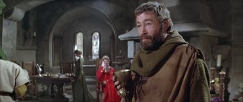 Movie still from “The Lion in Winter” (1968), directed by Anthony Harvey – A man holding a goblet while standing next to a woman; Medium shot, Over the shoulder angle