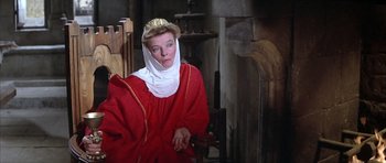 Movie still from “The Lion in Winter” (1968), directed by Anthony Harvey – A woman wearing a red robe and a crown; Medium shot, High angle