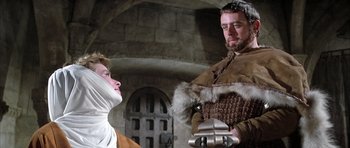 Movie still from “The Lion in Winter” (1968), directed by Anthony Harvey – A man in a brown jacket and a woman in a white dress; Medium shot, Low angle