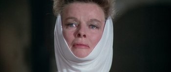Movie still from “The Lion in Winter” (1968), directed by Anthony Harvey – An older woman wearing a head scarf with eyes wide open; Close Up shot, Low angle