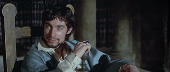 Movie still from “The Lion in Winter” (1968), directed by Anthony Harvey – A man sitting in a chair holding a ring; Close Up shot, Over the shoulder angle