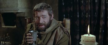 Movie still from “The Lion in Winter” (1968), directed by Anthony Harvey – A bearded man holding a cup in his hand; Medium shot, Over the shoulder angle